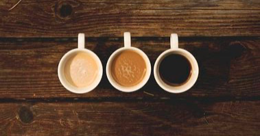 A picture of three coffee cups filled with 3 different types of coffee